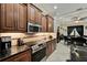 Kitchen featuring stainless appliances, wooden cabinets, granite countertops, and tile backsplash at 2512 61St E Ave, Ellenton, FL 34222