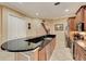 Modern kitchen features dark granite countertops, stainless steel appliances, and tile floors at 2512 61St E Ave, Ellenton, FL 34222