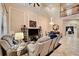Spacious living room with a high ceiling, a large TV, comfortable seating, and a decorative chandelier at 2512 61St E Ave, Ellenton, FL 34222