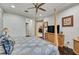 Serene bedroom featuring a four-poster bed, dark hardwood floors, and a glimpse into other rooms through the open doorway at 2512 61St E Ave, Ellenton, FL 34222