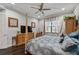 Comfortable bedroom with a four-poster bed, ceiling fan, and window offering natural light and a view at 2512 61St E Ave, Ellenton, FL 34222