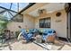 Outdoor patio area featuring comfortable seating, a ceiling fan, and a decorative lizard wall hanging at 2512 61St E Ave, Ellenton, FL 34222