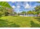 Beautiful backyard with lush green grass, complemented by mature trees and a partial view of the home at 2566 Tulip St, Sarasota, FL 34239
