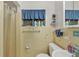Clean bathroom features a shower-tub combo with a blue shower curtain and fish decorations on the wall at 2566 Tulip St, Sarasota, FL 34239