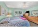 Comfortable bedroom featuring a ceiling fan, window, and light green painted walls at 2566 Tulip St, Sarasota, FL 34239