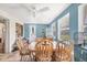Comfortable dining space with blue walls, large windows, and a dining set, illuminated by a ceiling fan at 2566 Tulip St, Sarasota, FL 34239
