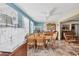 Cozy dining room with a round table, wood chairs, bird cage, and plenty of natural light at 2566 Tulip St, Sarasota, FL 34239
