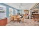 Bright dining room with blue walls, multiple windows, ceiling fan, and ample seating for Gathering meals at 2566 Tulip St, Sarasota, FL 34239