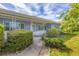 Charming home featuring a garden and pathway to a welcoming front entrance and beautiful plants at 2566 Tulip St, Sarasota, FL 34239
