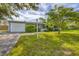 Inviting home featuring lush green lawn, mature tree, and a cozy exterior at 2566 Tulip St, Sarasota, FL 34239