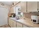 Bright kitchen features updated countertops, ample cabinet space, and modern stainless steel appliances for the home chef at 2566 Tulip St, Sarasota, FL 34239