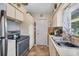 Efficient kitchen layout with stainless steel oven and refrigerator with tile backsplash and a window above the sink at 2566 Tulip St, Sarasota, FL 34239