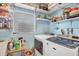 Bright laundry room with a washing machine, dryer, storage shelves, and a window at 2566 Tulip St, Sarasota, FL 34239