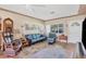 Inviting living room featuring leather seating, paintings on the walls, and tile flooring at 2566 Tulip St, Sarasota, FL 34239