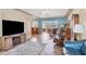Open-concept living area featuring a large tv, tile flooring, and bright, natural light at 2566 Tulip St, Sarasota, FL 34239