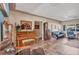 Inviting living room featuring tile floors, a piano, and comfortable seating with natural light from large windows at 2566 Tulip St, Sarasota, FL 34239