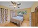 Cozy bedroom with hardwood floors, neutral walls, and a window overlooking the backyard at 2905 Bougainvillea St, Sarasota, FL 34239