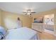 Bright bedroom features wood floors, ceiling fan, and ensuite bathroom with modern vanity at 2905 Bougainvillea St, Sarasota, FL 34239