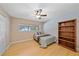 Bedroom features natural light, wood floors, and a cozy bed next to a bookshelf at 2905 Bougainvillea St, Sarasota, FL 34239