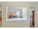 View of the dining area with modern table and chairs, seen through a cutout from another room at 2905 Bougainvillea St, Sarasota, FL 34239