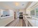 Modern kitchen featuring white cabinets, stainless steel appliances, and wood-look flooring, offering an open design at 2905 Bougainvillea St, Sarasota, FL 34239