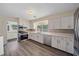 Modern kitchen featuring stainless steel appliances, white cabinets, and mosaic backsplash at 2905 Bougainvillea St, Sarasota, FL 34239