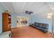 Comfortable living room with exposed beam ceiling, brick flooring, and an open floor plan at 2905 Bougainvillea St, Sarasota, FL 34239