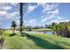 Beautiful backyard with a lush lawn, a long water view, and a wooden dock to the water at 31 Bunker Rd, Rotonda West, FL 33947