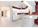 Well-lit kitchen featuring white cabinetry and appliances with a view into the adjacent living and dining areas at 31 Bunker Rd, Rotonda West, FL 33947