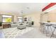 Stylishly decorated living area featuring tile flooring, neutral décor, and an adjacent bar with seating at 31 Bunker Rd, Rotonda West, FL 33947