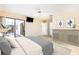 Spacious main bedroom features a ceiling fan, gray dresser, and sliding glass doors to the lanai at 31 Bunker Rd, Rotonda West, FL 33947