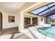 Covered lanai area with an outdoor seating area and view of the screened-in pool at 31 Bunker Rd, Rotonda West, FL 33947