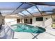 Inviting screened-in pool with a see-through roof section and plenty of space for entertaining at 31 Bunker Rd, Rotonda West, FL 33947