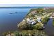Waterfront estate featuring lush landscaping and a private dock, offering stunning views of the serene bay at 336 S Orchid Dr, Ellenton, FL 34222