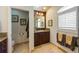 Well-lit bathroom features dark wood cabinetry, granite countertops, and tiled floors, a luxurious space at 336 S Orchid Dr, Ellenton, FL 34222
