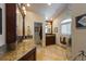 Elegant bathroom with dual sinks, tiled floors, and a glass-enclosed shower creates a spa-like experience at 336 S Orchid Dr, Ellenton, FL 34222