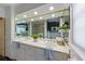 A luxurious bathroom features double sinks, a framed mirror, and decorative plants adding sophistication at 336 S Orchid Dr, Ellenton, FL 34222