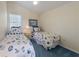 Bright bedroom featuring two twin beds with matching bedding and a large window at 336 S Orchid Dr, Ellenton, FL 34222