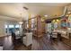 Spacious dining room with a glass-top table, wood floors, and elegant lighting fixtures at 336 S Orchid Dr, Ellenton, FL 34222