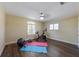 Bright exercise room featuring hard floors, ceiling fan, and natural light from windows with plantation shutters at 336 S Orchid Dr, Ellenton, FL 34222