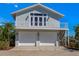 Charming two-story coastal home featuring a two-car garage and balcony with bright white railing at 336 S Orchid Dr, Ellenton, FL 34222