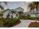 Well landscaped single Gathering home featuring mature trees and manicured bushes surrounding the property at 336 S Orchid Dr, Ellenton, FL 34222