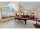 Well-lit game room with pool table, bench seating, wet bar, and high ceilings at 336 S Orchid Dr, Ellenton, FL 34222
