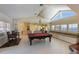 Bright game room featuring a pool table, built-in bench seating, and views of the water at 336 S Orchid Dr, Ellenton, FL 34222