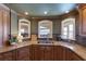 Gourmet kitchen with custom cabinets, stainless sink, granite countertops, and waterfront view at 336 S Orchid Dr, Ellenton, FL 34222