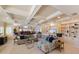 Inviting living room featuring a comfortable sectional sofa and built-in shelving with tiled floor at 336 S Orchid Dr, Ellenton, FL 34222