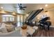 Spacious living room with a piano, staircase, and natural light at 336 S Orchid Dr, Ellenton, FL 34222