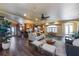 Open-concept living room with wood floors, a ceiling fan, and plenty of seating at 336 S Orchid Dr, Ellenton, FL 34222