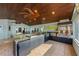 A full outdoor kitchen is equipped with a refrigerator, grill, stainless steel hood, and sink for easy entertaining at 336 S Orchid Dr, Ellenton, FL 34222