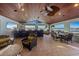 Entertain in style in this outdoor space with a kitchen, bar, dining area, multiple ceiling fans, and panoramic views at 336 S Orchid Dr, Ellenton, FL 34222